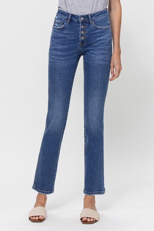 A classic button up jean with a comfortable stretch denim fabric. This mid rise straight leg jean features a versatile cut and elongated hem to create a sleek silhouette with plenty of coverage. A flattering wash that makes it great for pairing with heels or sneakers, this is a must have piece for your wardrobe. Avah Couture