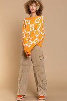 Our most popular style, this oversized sweater top is crafted with a round neckline and long sleeves for easy layering. A unique flower and checkerboard pattern creates an eye catching look. Ribbed edges add graphic detail and make it easy to pair with your favorite jeans or leggings. The irresistible oversized fit will never go out of style! Avah Couture