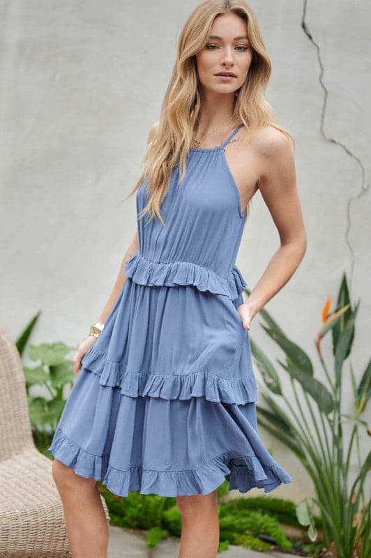 Let the sun shine in with this halter top sundress. Featuring ruffles and tiers, it’s the perfect mix of comfortable and cute. With pockets to keep you organized, this is the best mini dress you need to add to your closet. Avah Couture