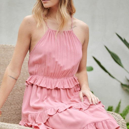 Let the sun shine in with this halter top sundress. Featuring ruffles and tiers, it’s the perfect mix of comfortable and cute. With pockets to keep you organized, this is the best mini dress you need to add to your closet. Avah Couture