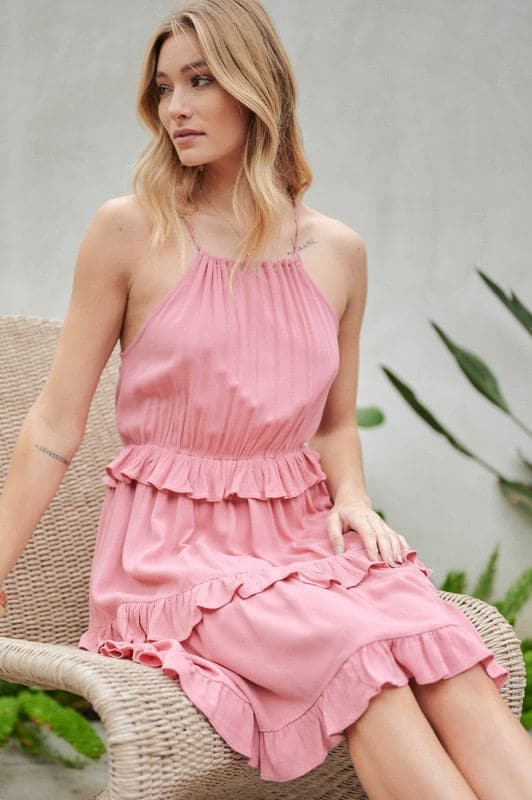 Let the sun shine in with this halter top sundress. Featuring ruffles and tiers, it’s the perfect mix of comfortable and cute. With pockets to keep you organized, this is the best mini dress you need to add to your closet. Avah Couture