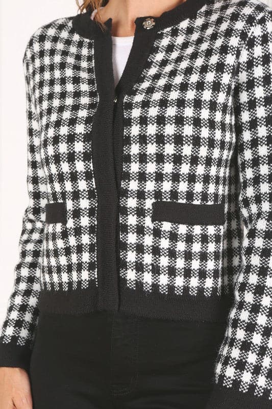 A classic piece that has timeless style, the Black And White Check Jacket is a must have this season. The heavy weight knit fabric features a black and white check pattern that gives it its name. A perfect balance of comfort and style, this jacket features 4 front snap buttons and 2 functional pockets. Wear it with your favorite outfit to work or play a classic piece to get you through any occasion! Avah Couture