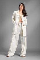 Rock this suit when you want a little seduction with your power.  An ultimate high-end look for any season - you can dress it down or dress it up with your favorite accessories to create a unique style all your own. This chic set features a single-button oversized blazer and pants with side pockets and an elastic waistband at the back. It is made of a soft polyblend material that feels luxurious, breathable, and lightweight. Avah Couture