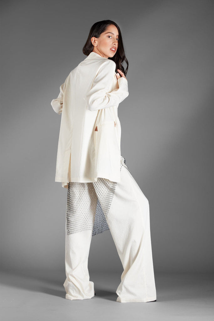 Rock this suit when you want a little seduction with your power.  An ultimate high-end look for any season - you can dress it down or dress it up with your favorite accessories to create a unique style all your own. This chic set features a single-button oversized blazer and pants with side pockets and an elastic waistband at the back. It is made of a soft polyblend material that feels luxurious, breathable, and lightweight. Avah Couture