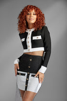 Feel like a queen in sheer elegance with the Revealed for Glory Two-Piece skirt suit. (Metal Mesh Rhinestone Overlay Sold Separately)  You'll look regal in this white and black bandage top jacket and mini skirt. In addition to being a fierce fashion statement, the thick stretch material of this set allows for the most flattering fit while the gold buttons and decorative pockets add a touch of sophisticated style. Wear it as a set or split it up, the possibilities are endless. Avah Couture