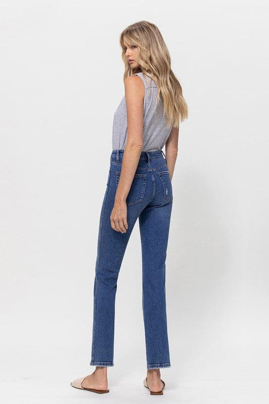 A classic button up jean with a comfortable stretch denim fabric. This mid rise straight leg jean features a versatile cut and elongated hem to create a sleek silhouette with plenty of coverage. A flattering wash that makes it great for pairing with heels or sneakers, this is a must have piece for your wardrobe. Avah Couture