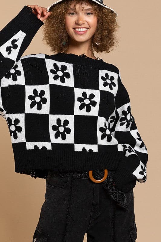 Our most popular style, this oversized sweater top is crafted with a round neckline and long sleeves for easy layering. A unique flower and checkerboard pattern creates an eye catching look. Ribbed edges add graphic detail and make it easy to pair with your favorite jeans or leggings. The irresistible oversized fit will never go out of style! Avah Couture