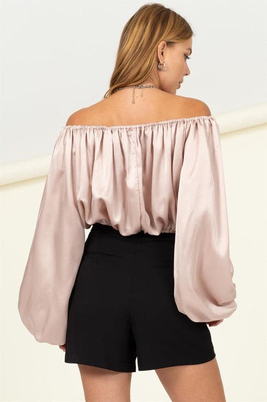 Off the shoulder blouse: a timeless trend that never goes out of style. This cropped top features a flattering off the shoulder neckline and loose fit for a feminine silhouette, finished with flared sleeves for that extra dramatic moment. Wear yours with high waisted jeans or trousers for effortless style!   Avah Couture