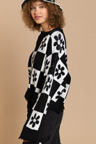 Our most popular style, this oversized sweater top is crafted with a round neckline and long sleeves for easy layering. A unique flower and checkerboard pattern creates an eye catching look. Ribbed edges add graphic detail and make it easy to pair with your favorite jeans or leggings. The irresistible oversized fit will never go out of style! Avah Couture