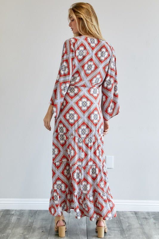 Back view of red orange duster with bold geometric print and flowy hemline – AVAH