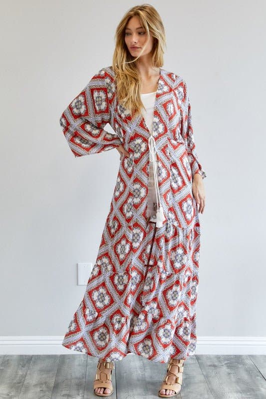 Front view of model in red geometric printed duster with white tassel tie – AVAH