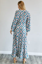 Back view of teal geometric duster showing tiered hem and relaxed fit – AVAH