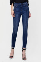 These jeans are cut from comfy stretch denim to sit on your hips and have a high rise that creates a smooth, sculpted shape. We love the ankle skinny fit and uneven hem, perfect to show off your favorite pair of shoes! Avah Couture