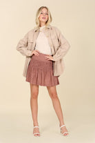 This contemporary light beige shacket is a perfect piece to add to your stylish wardrobe. Style with your favorite jeans and boots, or wear it with a pencil skirt and heels for an impeccable office look. Features collared neckline, button front, two chest pockets, long sleeves and single button at the cuff. Avah Couture