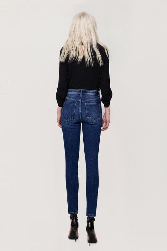 These jeans are cut from comfy stretch denim to sit on your hips and have a high rise that creates a smooth, sculpted shape. We love the ankle skinny fit and uneven hem, perfect to show off your favorite pair of shoes! Avah Couture