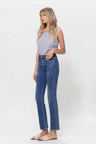 A classic button up jean with a comfortable stretch denim fabric. This mid rise straight leg jean features a versatile cut and elongated hem to create a sleek silhouette with plenty of coverage. A flattering wash that makes it great for pairing with heels or sneakers, this is a must have piece for your wardrobe. Avah Couture