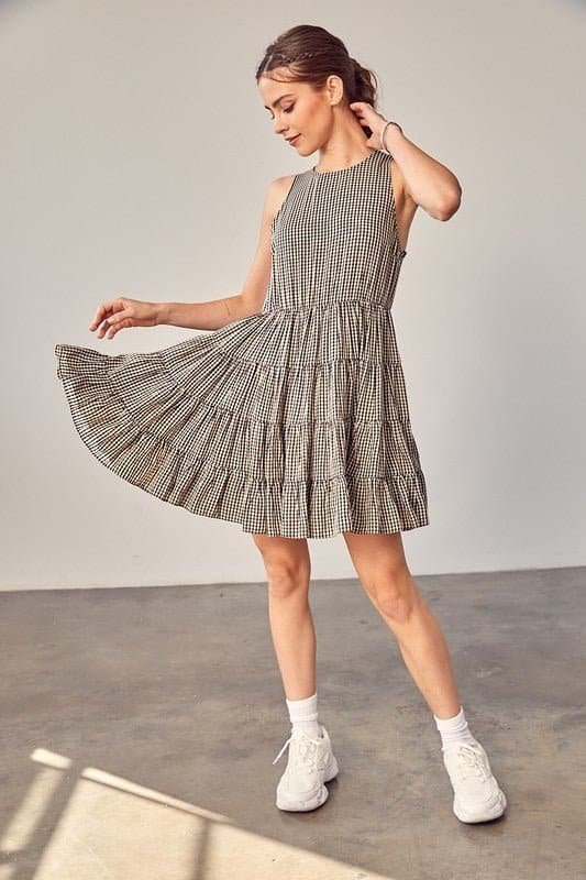 Sweet Things Gingham Tiered Mini Dress - Avah Couture-Adorable little tiered Gingham dress for some on-trend spring and summer fun. This mini dress is the perfect casual dress for all you sweet summer days. Sweet Things Gingham Tiered Mini Dress is sleeveless, has a jewel neckline and keyhole back with tie. Self: 70% Polyester, 30% Rayon. Lining: 100% Rayon- Black